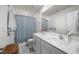 Bathroom with a double vanity, quartz countertop, brushed nickel faucets, and patterned shower curtain at 2415 Ivy Knoll Dr, Mebane, NC 27302