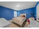 Bedroom featuring carpet, blue walls, and a window at 2415 Ivy Knoll Dr, Mebane, NC 27302