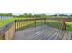 Wooden deck with railing overlooking the backyard and a partial view of the landscape at 2415 Ivy Knoll Dr, Mebane, NC 27302