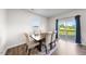 Bright dining room with hardwood floors, neutral walls, and a view of the outdoors at 2415 Ivy Knoll Dr, Mebane, NC 27302