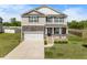 Charming two-story home boasts a stone facade, inviting front porch, and a well-manicured lawn at 2415 Ivy Knoll Dr, Mebane, NC 27302