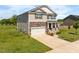 Charming two-story home boasts stone accents, a two-car garage, and a well-manicured lawn at 2415 Ivy Knoll Dr, Mebane, NC 27302