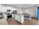 Bright kitchen features stainless steel appliances, an island with granite countertops, and hardwood floors at 2415 Ivy Knoll Dr, Mebane, NC 27302