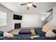 Cozy living room with a fireplace, TV, comfortable blue sectional, and staircase at 2415 Ivy Knoll Dr, Mebane, NC 27302