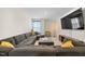 Spacious living room featuring a sectional sofa, a media console, and a large screen television at 2415 Ivy Knoll Dr, Mebane, NC 27302