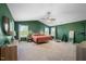 Large main bedroom featuring high ceilings, multiple windows, and neutral carpet at 2415 Ivy Knoll Dr, Mebane, NC 27302
