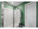 This bathroom features a glass shower door, tiled shower and white fixtures at 2415 Ivy Knoll Dr, Mebane, NC 27302