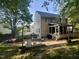 Landscaped backyard with patio, seating area, and lush greenery, perfect for entertaining at 2540 Beech Gap Ct, Raleigh, NC 27603