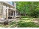Spacious backyard with a screened porch, patio, and lush greenery at 2540 Beech Gap Ct, Raleigh, NC 27603