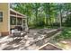 Relax on this backyard patio with a stone fire pit, string lights and access to a screened porch at 2540 Beech Gap Ct, Raleigh, NC 27603