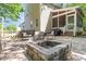 Enjoy this stone patio with an outdoor fire pit, seating, and screened porch access at 2540 Beech Gap Ct, Raleigh, NC 27603