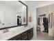 Bright bathroom with double vanity, large mirror, and a walk-in closet at 2540 Beech Gap Ct, Raleigh, NC 27603