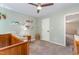 Light and airy bedroom featuring a crib, bookshelf, ceiling fan and grey carpet at 2540 Beech Gap Ct, Raleigh, NC 27603