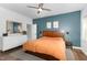 Comfortable bedroom with an orange bedspread, ceiling fan, and modern decor at 2540 Beech Gap Ct, Raleigh, NC 27603