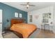 Comfortable bedroom with a wooden headboard bed, ceiling fan, and a work area at 2540 Beech Gap Ct, Raleigh, NC 27603