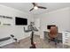 Workout room featuring exercise bike, desk, TV, shelves and ceiling fan at 2540 Beech Gap Ct, Raleigh, NC 27603