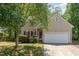 Charming two-story home featuring a well-maintained lawn, lush tree, and attached two-car garage at 2540 Beech Gap Ct, Raleigh, NC 27603