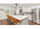 Bright kitchen with a large island, stainless steel appliances, white cabinetry, and modern fixtures at 2540 Beech Gap Ct, Raleigh, NC 27603