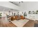 Open concept living room with a large couch and decor flowing into the kitchen and dining area at 2540 Beech Gap Ct, Raleigh, NC 27603