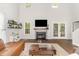 Bright living room featuring fireplace, hardwood floors, and glass top coffee table at 2540 Beech Gap Ct, Raleigh, NC 27603
