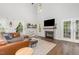 Bright living room boasts a modern fireplace, hardwood floors, and comfortable leather seating at 2540 Beech Gap Ct, Raleigh, NC 27603