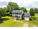 Traditional two-story home with gray siding, black shutters, and a large, grassy yard at 3004 Red Cir, Willow Springs, NC 27592