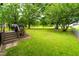 Spacious backyard with deck, grill, swing and ample green space at 3004 Red Cir, Willow Springs, NC 27592