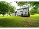 Backyard with a deck, lush green grass, and mature trees at 3004 Red Cir, Willow Springs, NC 27592