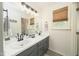 Bathroom with double sinks, modern vanity, and a well lit mirror at 3004 Red Cir, Willow Springs, NC 27592
