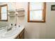 Bright bathroom featuring a modern sink, vanity, and a window providing natural light at 3004 Red Cir, Willow Springs, NC 27592