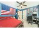 This bedroom features blue walls adorned with posters and equipped with a desk and a red bed at 3004 Red Cir, Willow Springs, NC 27592