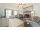 Bright and airy living room with a brick fireplace, comfortable seating, and natural light from large windows at 3004 Red Cir, Willow Springs, NC 27592