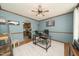 Well-lit office with a ceiling fan, a modern desk, and an adjacent view into the kitchen at 3004 Red Cir, Willow Springs, NC 27592