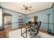 A cozy office space with a comfortable chair, a ceiling fan, and view into the living room at 3004 Red Cir, Willow Springs, NC 27592