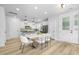 Bright dining area featuring an island with seating and pendant lights; open concept to kitchen with stainless steel appliances at 3018 White Rail Dr, Fuquay Varina, NC 27526