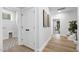Bright hallway with contemporary design, including wood floors, access to a laundry room and stairwell at 3018 White Rail Dr, Fuquay Varina, NC 27526