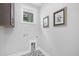 Functional laundry room with sleek tile floor, ample wall art, and modern hookups for washer and dryer at 3018 White Rail Dr, Fuquay Varina, NC 27526