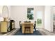 Bright dining room featuring a wooden table, stylish black chairs, and modern decor at 334 Carolina Springs Blvd, Apex, NC 27539