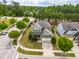 An aerial shot showcasing a well-maintained green home, situated on a manicured lot at 364 Springtime Fields Ln, Wake Forest, NC 27587