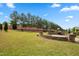 A beautifully landscaped backyard features a stone patio with a built-in grill, perfect for outdoor entertaining at 364 Springtime Fields Ln, Wake Forest, NC 27587