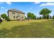 Spacious backyard with an outdoor grill area, mature trees, and lush green grass, perfect for outdoor living at 364 Springtime Fields Ln, Wake Forest, NC 27587