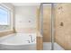 Bathroom features a large soaking tub and a glass enclosed shower at 364 Springtime Fields Ln, Wake Forest, NC 27587