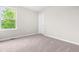 Bright bedroom with plush carpeting and a large window to view the outdoors at 364 Springtime Fields Ln, Wake Forest, NC 27587