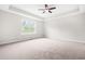 Large bedroom with a tray ceiling and carpeting has natural lighting at 364 Springtime Fields Ln, Wake Forest, NC 27587