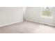 Empty bedroom with soft neutral carpet, trim, and a view to outside at 364 Springtime Fields Ln, Wake Forest, NC 27587