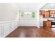 Dining area featuring hardwood flooring, crown moulding, and stainless steel appliances at 364 Springtime Fields Ln, Wake Forest, NC 27587