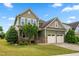 Two-story home featuring a two-car garage, stone accents, and a well-maintained lawn at 364 Springtime Fields Ln, Wake Forest, NC 27587