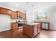 Bright kitchen features wood cabinets, stainless appliances, granite countertops, and center island at 364 Springtime Fields Ln, Wake Forest, NC 27587