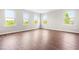 Spacious living area with hardwood floors and multiple windows bringing in natural light at 364 Springtime Fields Ln, Wake Forest, NC 27587