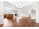 Open floor plan featuring hardwood flooring, an eat in kitchen, a fireplace, and stairs at 364 Springtime Fields Ln, Wake Forest, NC 27587